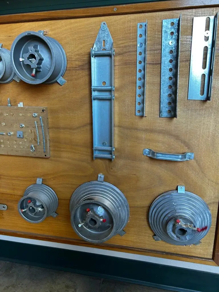 Garage door parts including rollers and brackets.