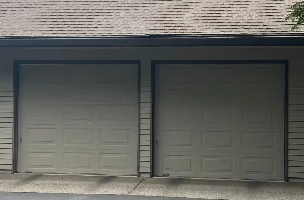 Two single car garage doors, green color